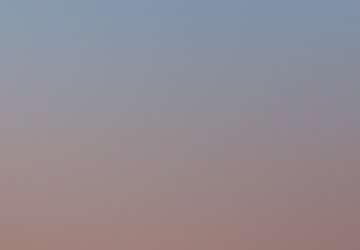 A pale moonlike glow in a dark field